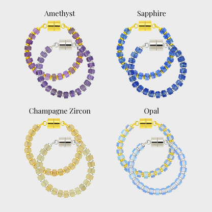 Her Majesty wine charm set showing each color name: Amethyst, Sapphire, Champagne Zircon and Opal