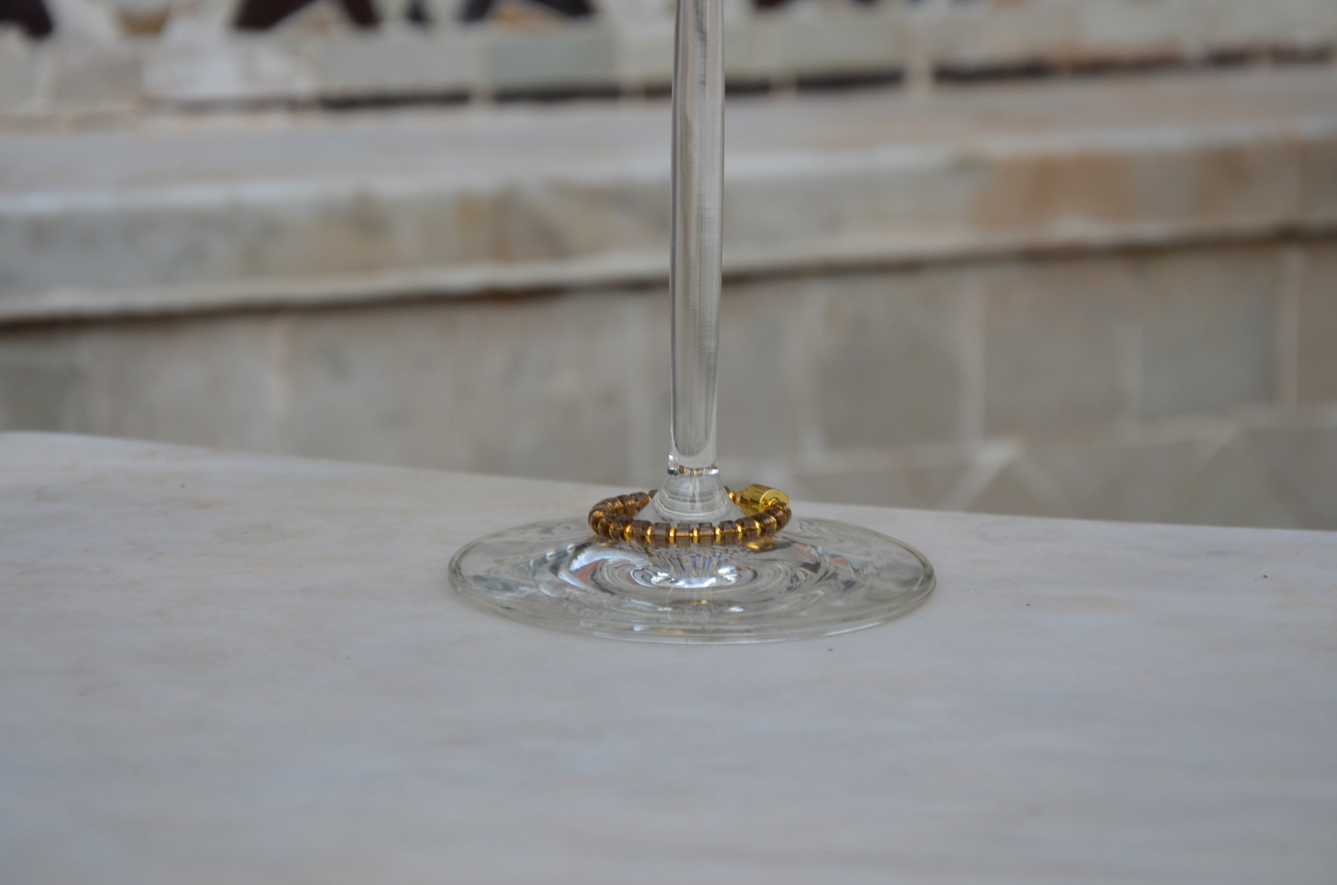 Smoky Quartz magnetic wine charm with gold hardware on a wine glass