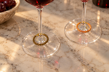 Magnetic wine charms by House of Hez displayed on wine glasses